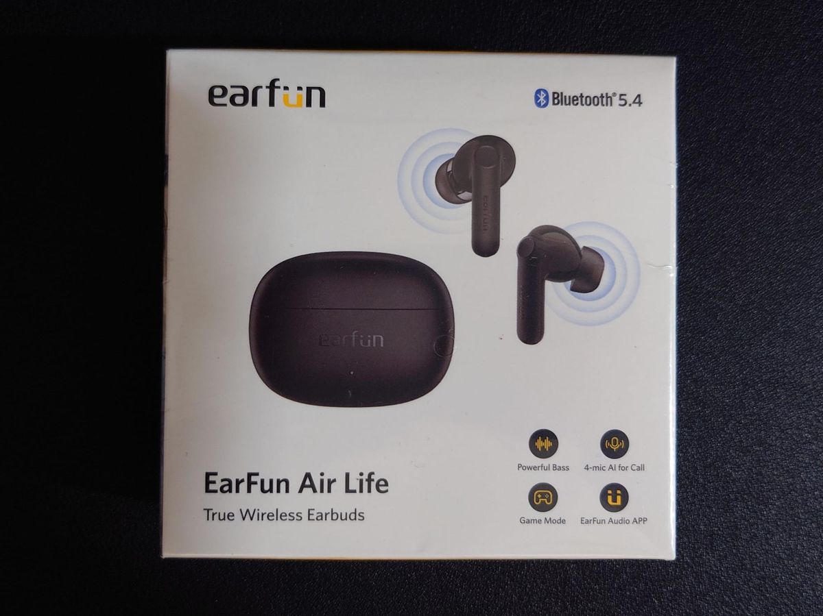 Photo of the box the earbuds come in, listing features such as 4 mics for calls, powerful bass, and audio app