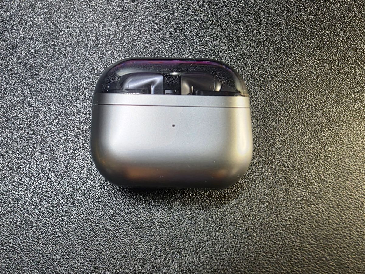 Samsung Galaxy Buds3 Pro, inside their closed case on a black background