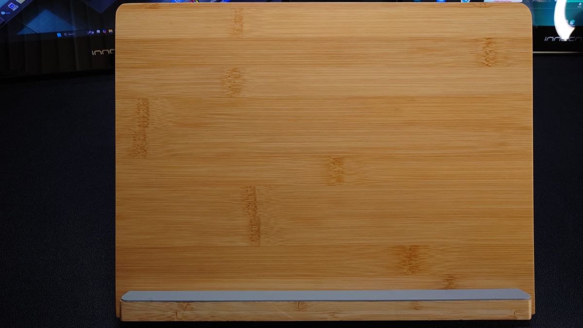 Photo of a wooden tablet stand with a gray rubber base for the tablet to sit on