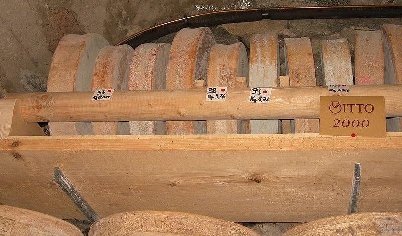 Bitto Cheese, stack in the wooden rack