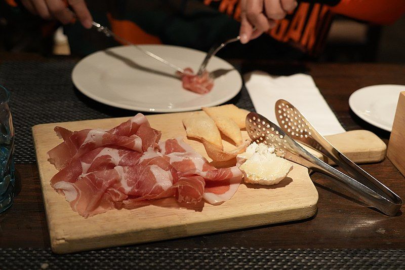 Sliced Culatello on wooden board