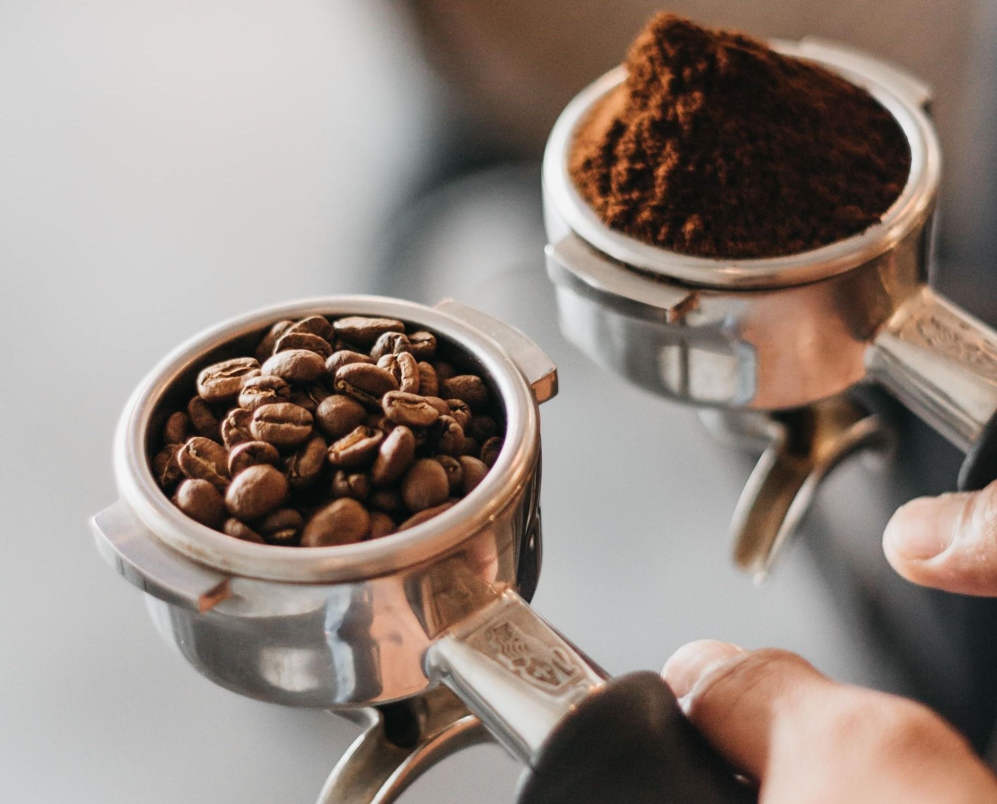 person holding gray coffee racks