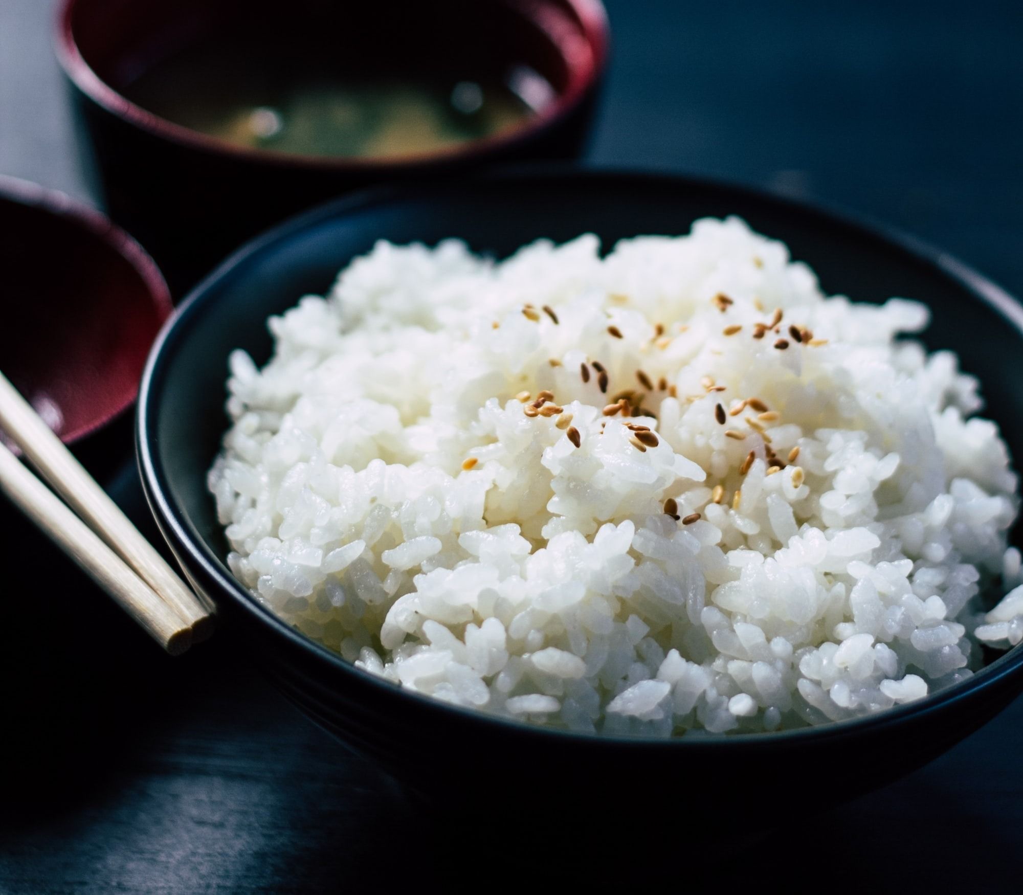 rice with sesame in black bowl