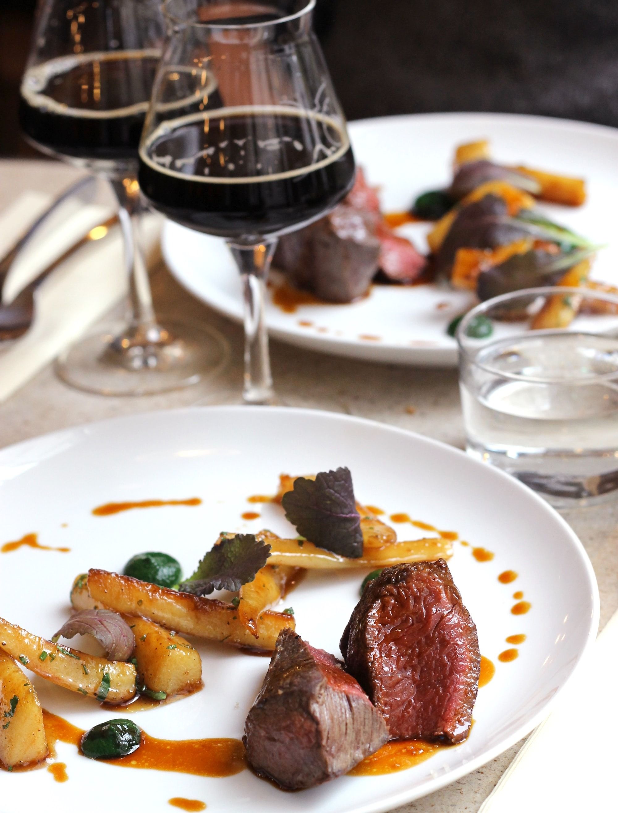 steak and vegetable on plate with wine