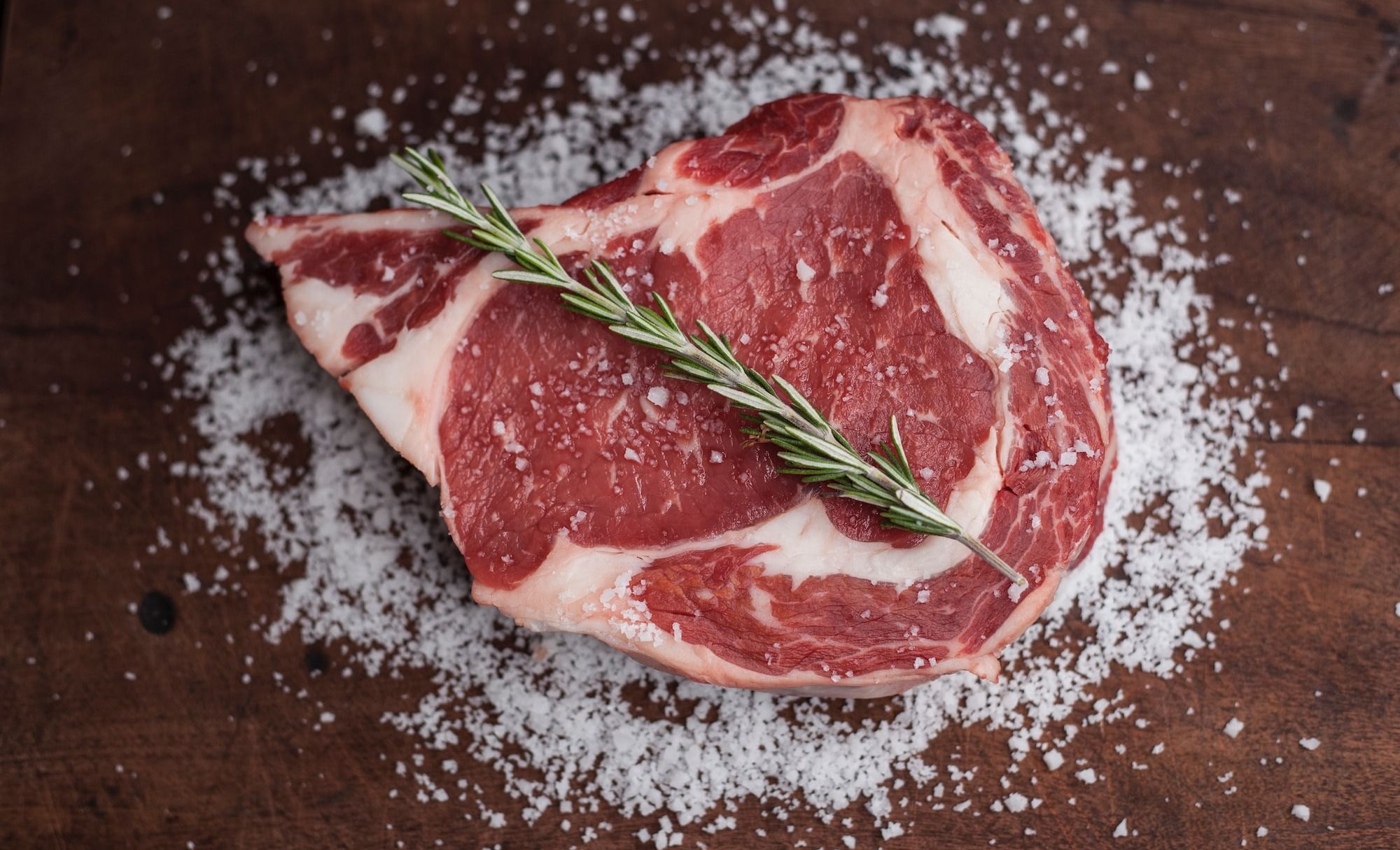raw meat on brown wooden table