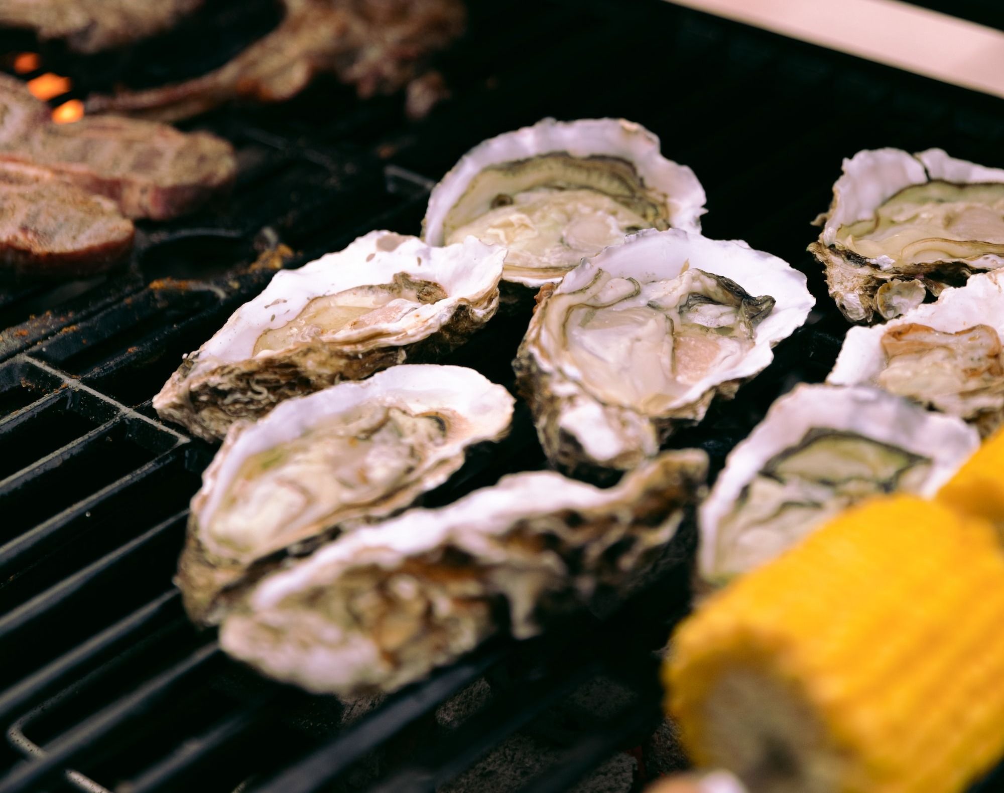 white and brown mushrooms on black grill