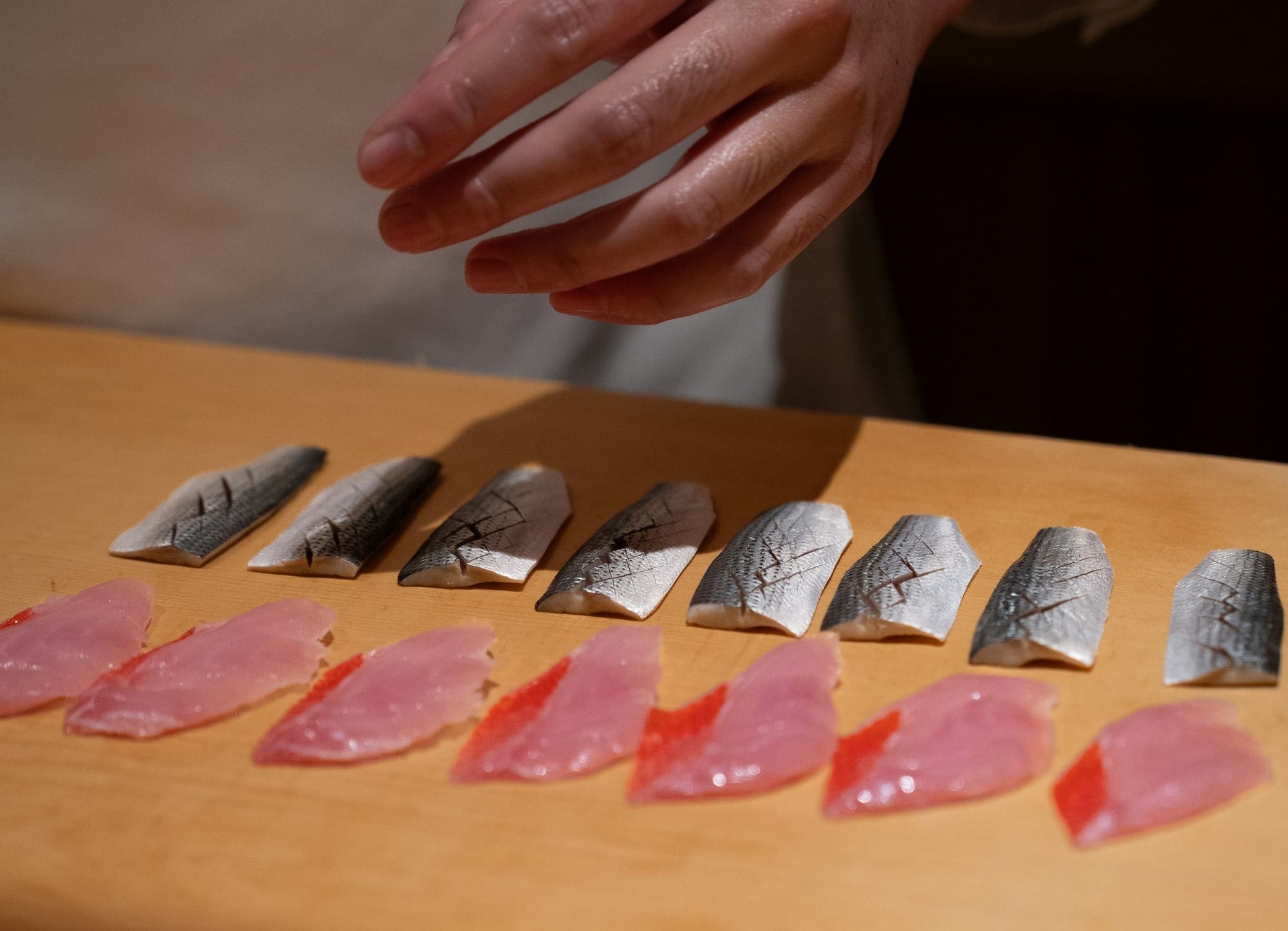 Sushi chef prepares fresh fish slices Mackerel Sashimi