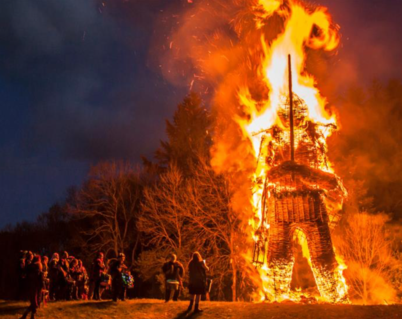 Photo of large wicker man effigy being burnt during an ancient ceremony