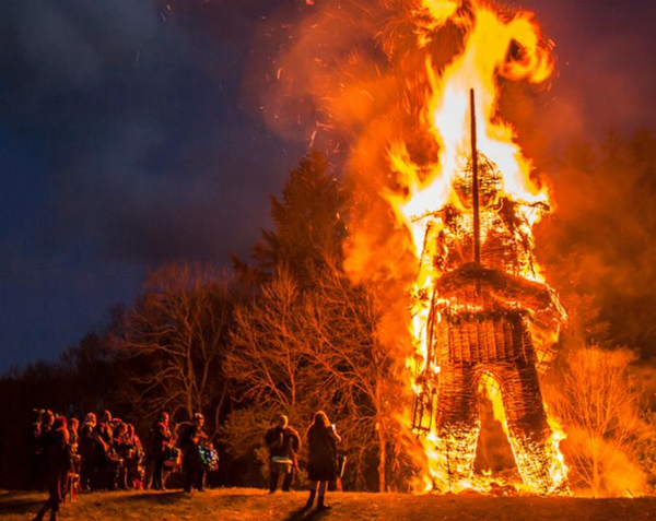 Photo of large wicker man effigy being burnt during an ancient ceremony