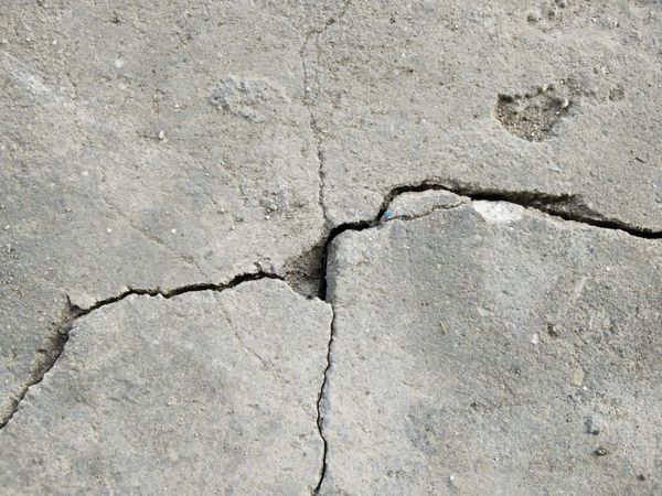 A photo of cracks in a concrete floor
