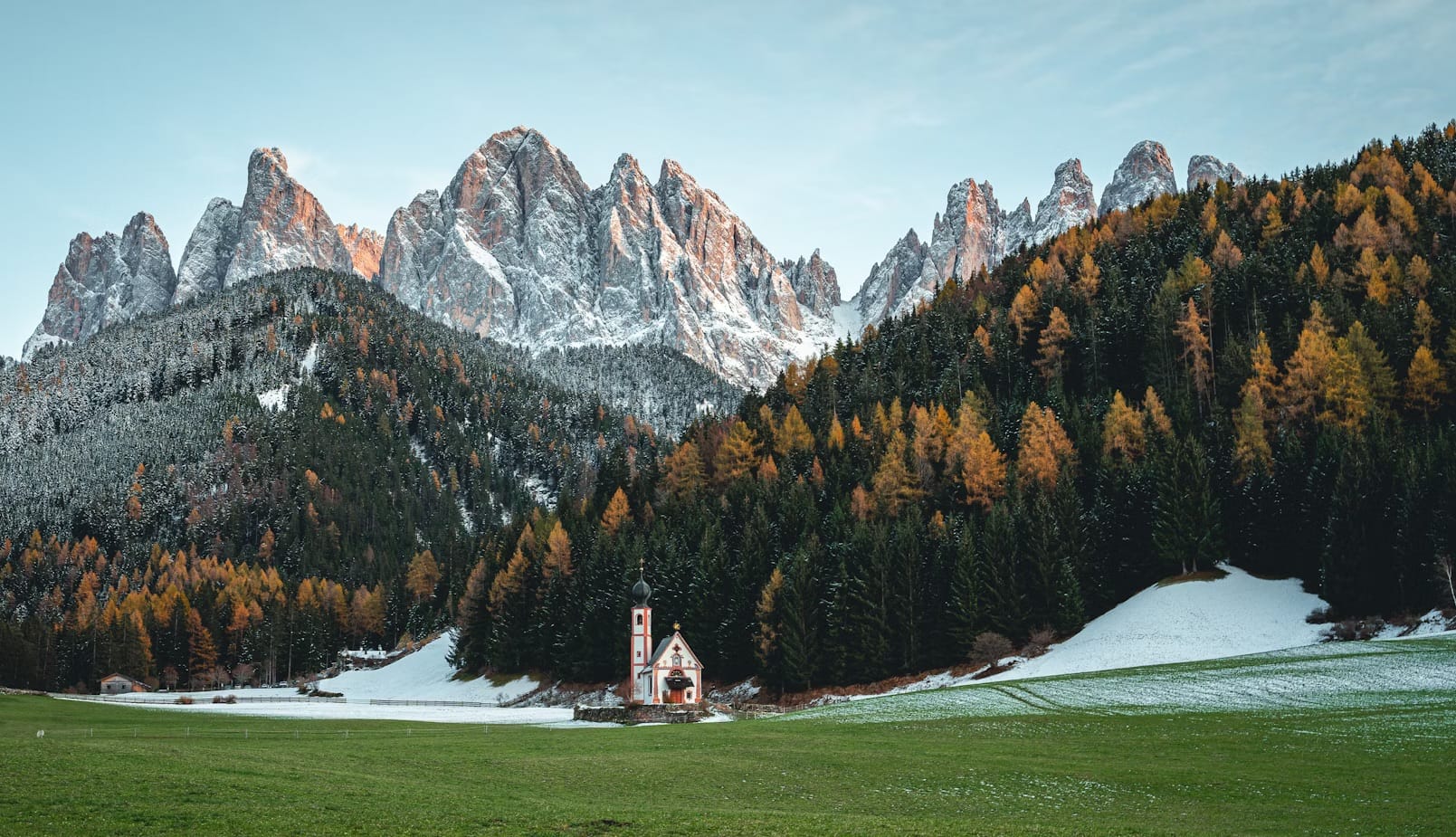 The jagged peaks of the Puez-Odle UNESCO system glowing pink at sunset, a phenomenon known as Enrosadira in the Italian Dolomites.