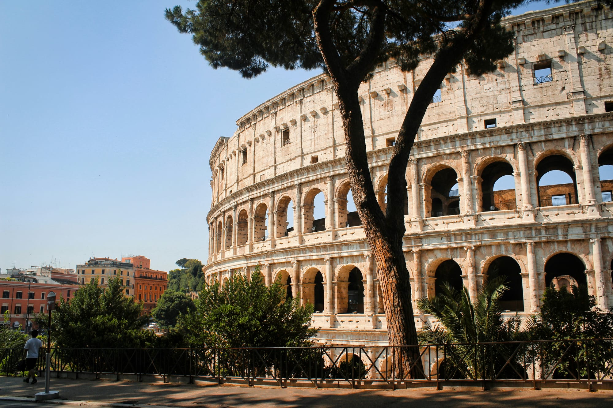 The Roman Colosseum illuminated by the golden light of dawn.