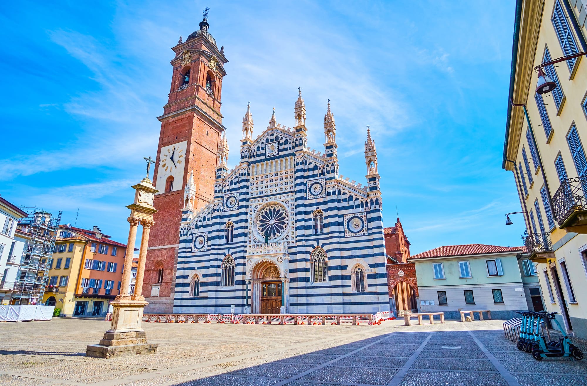 The striking black-and-white marble facade of the Duomo di Monza, a masterpiece of Lombard Gothic architecture located in the historic center of Monza, Italy.