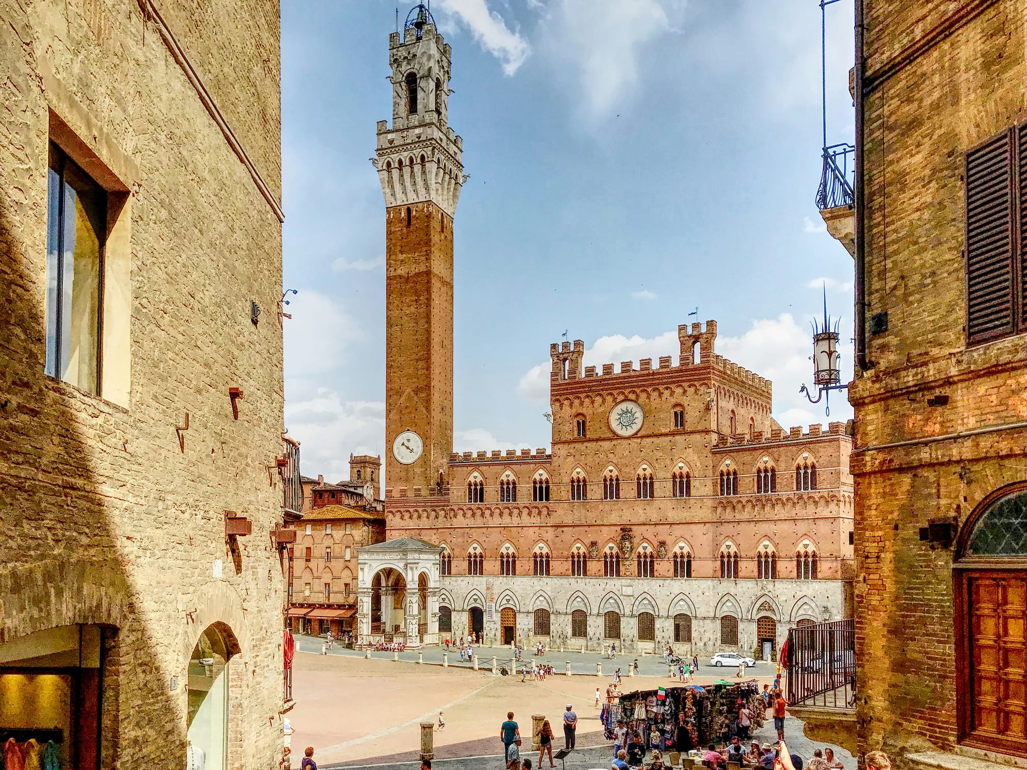 Unusual view of Siena's unique, shell-shaped Piazza del Campo, with the Torre del Mangia standing tall.