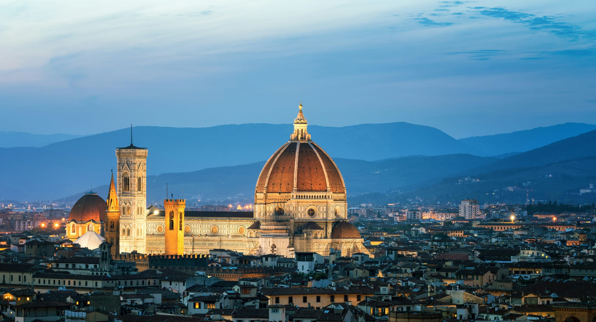 During the magic of the blue hour, the skyline of Florence, Italy, is bathed in an ethereal glow, with the Duomo standing in stark contrast to the night sky.