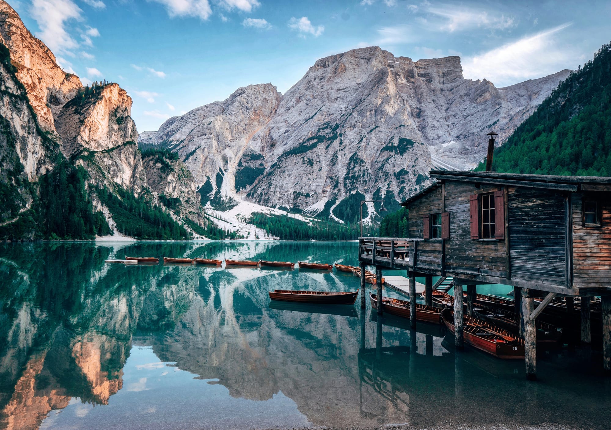 Blue lake and jagged peaks of the Dolomites mountains in Northern Italy, perfect for an adventurous addition to an Italy trip.