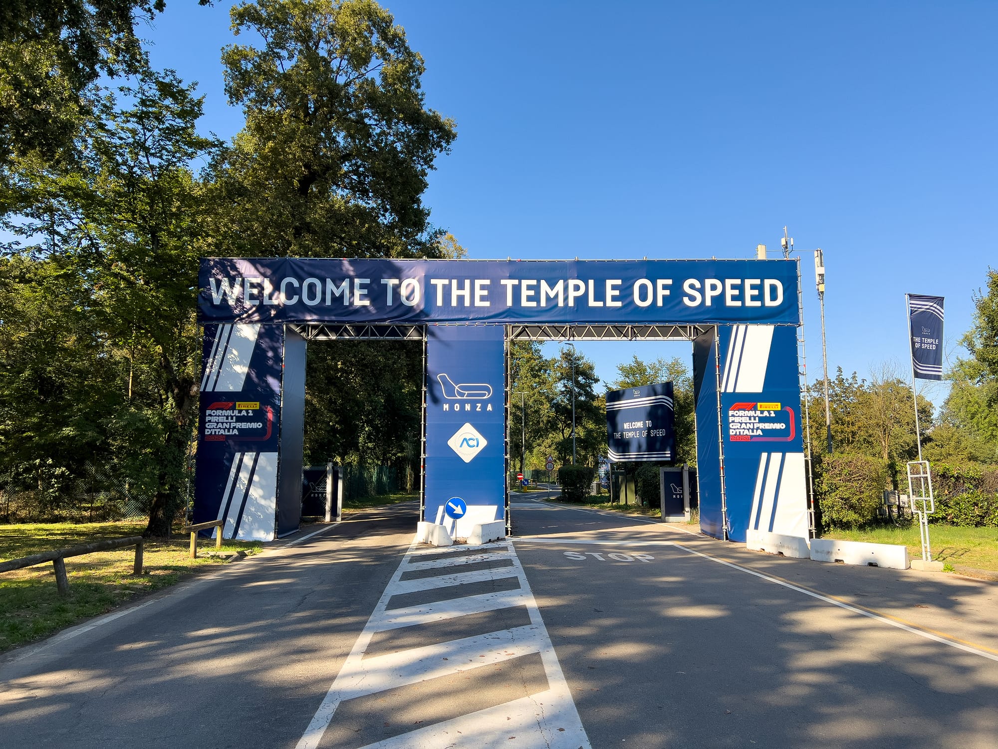 The entrance gate to the Autodromo Nazionale Monza with a large sign that reads 'Welcome to the Temple of Speed.'