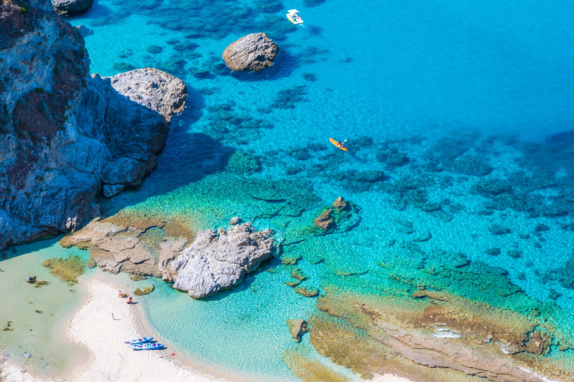 Top-down aerial view of the secluded Praia di Fuoco beach near Capo Vaticano, on the Costa degli Dei in Calabria, showing its pristine sand and clear turquoise water.