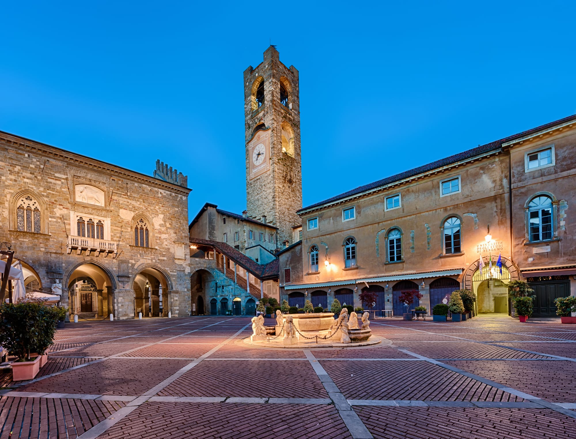 The historic Piazza Vecchia in the heart of Bergamo's Città Alta, with the Campanone tower, Palazzo della Ragione, and Contarini fountain.