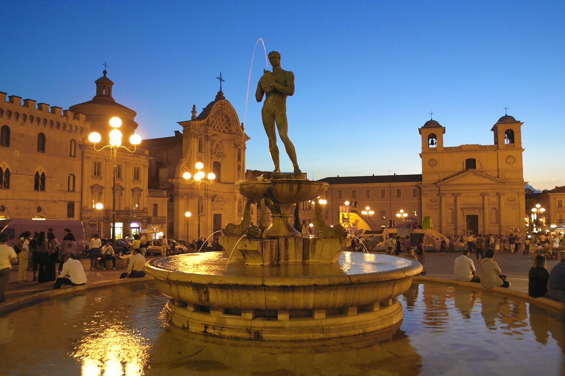 Historic view of Piazza Duomo and the fountain in L'Aquila, Abruzzo, before the city's architectural restoration.