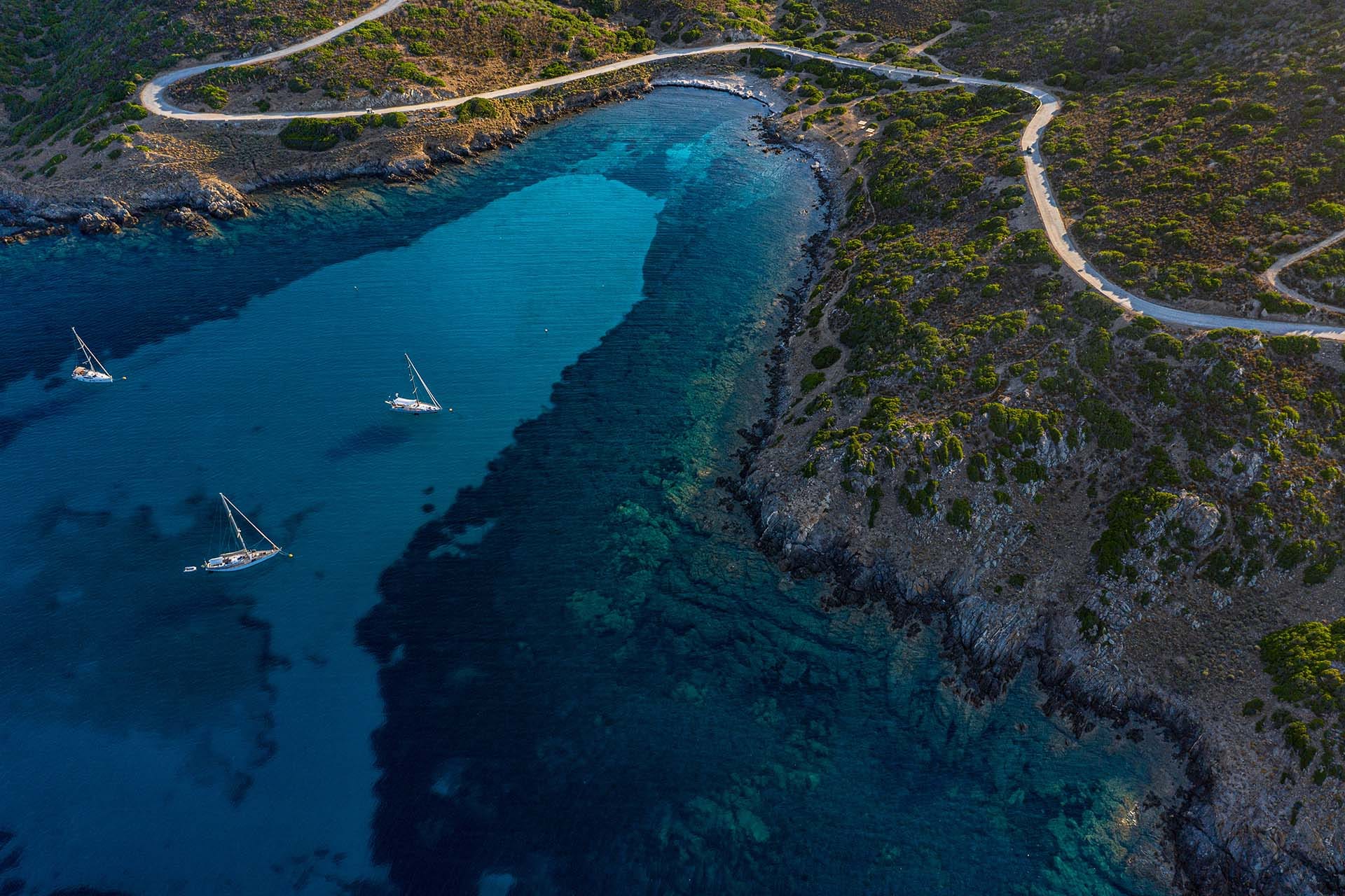 Aerial drone view of pristine beach and turquoise water in Asinara National Park, northwestern Sardinia, Italy.
