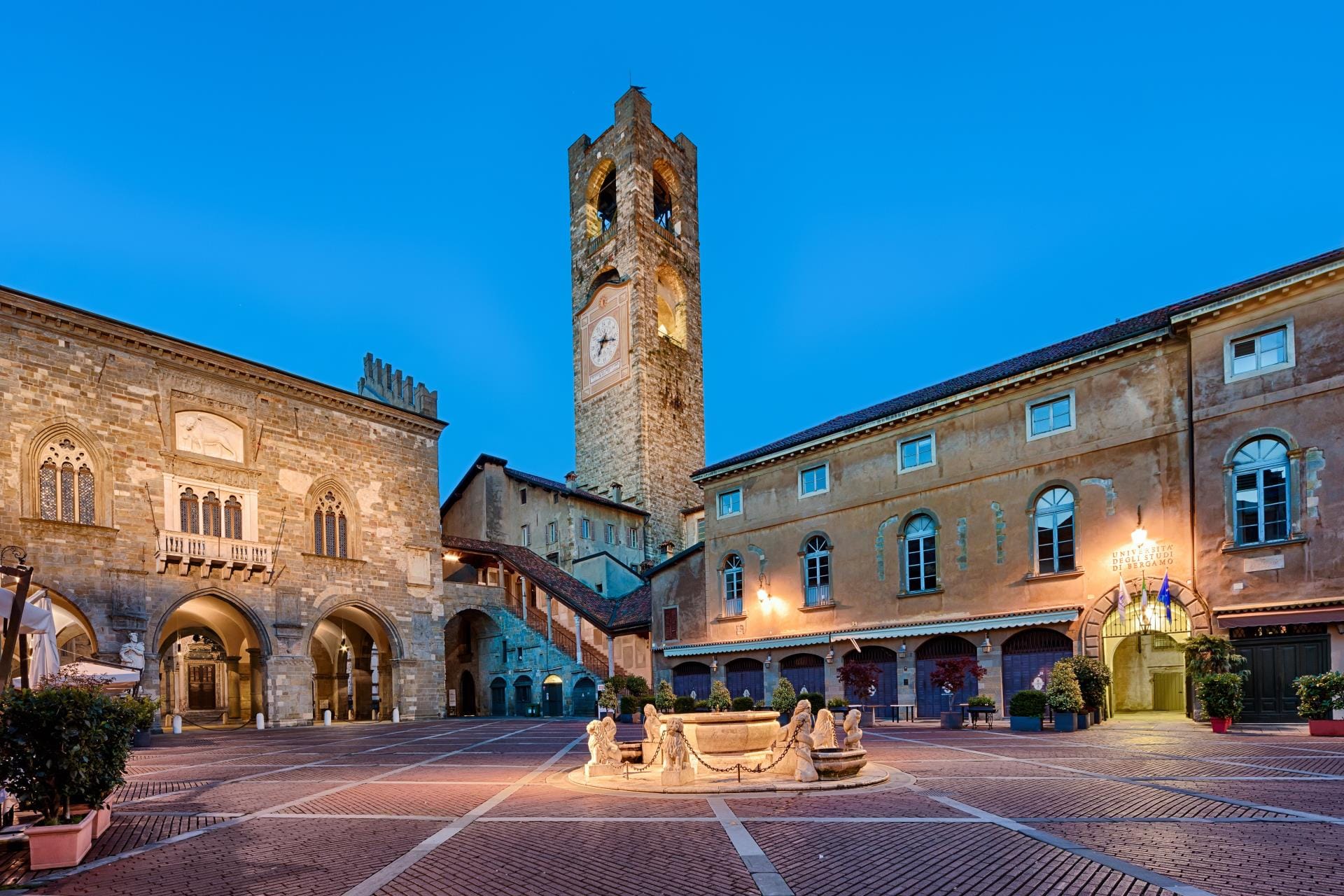 The historic Piazza Vecchia in Bergamo captured during the evening blue hour with the Palazzo della Ragione.