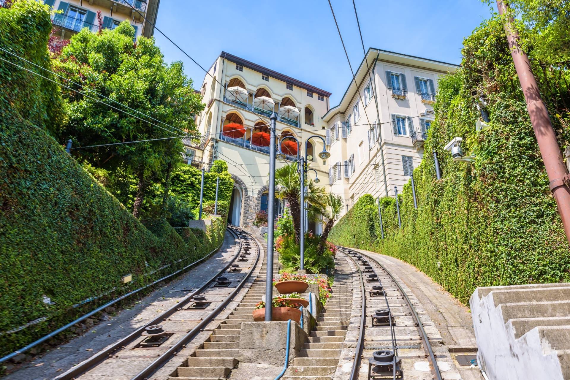 Scenic summer panorama of Città Alta houses and winding roads viewed from the San Vigilio funicular in Bergamo.