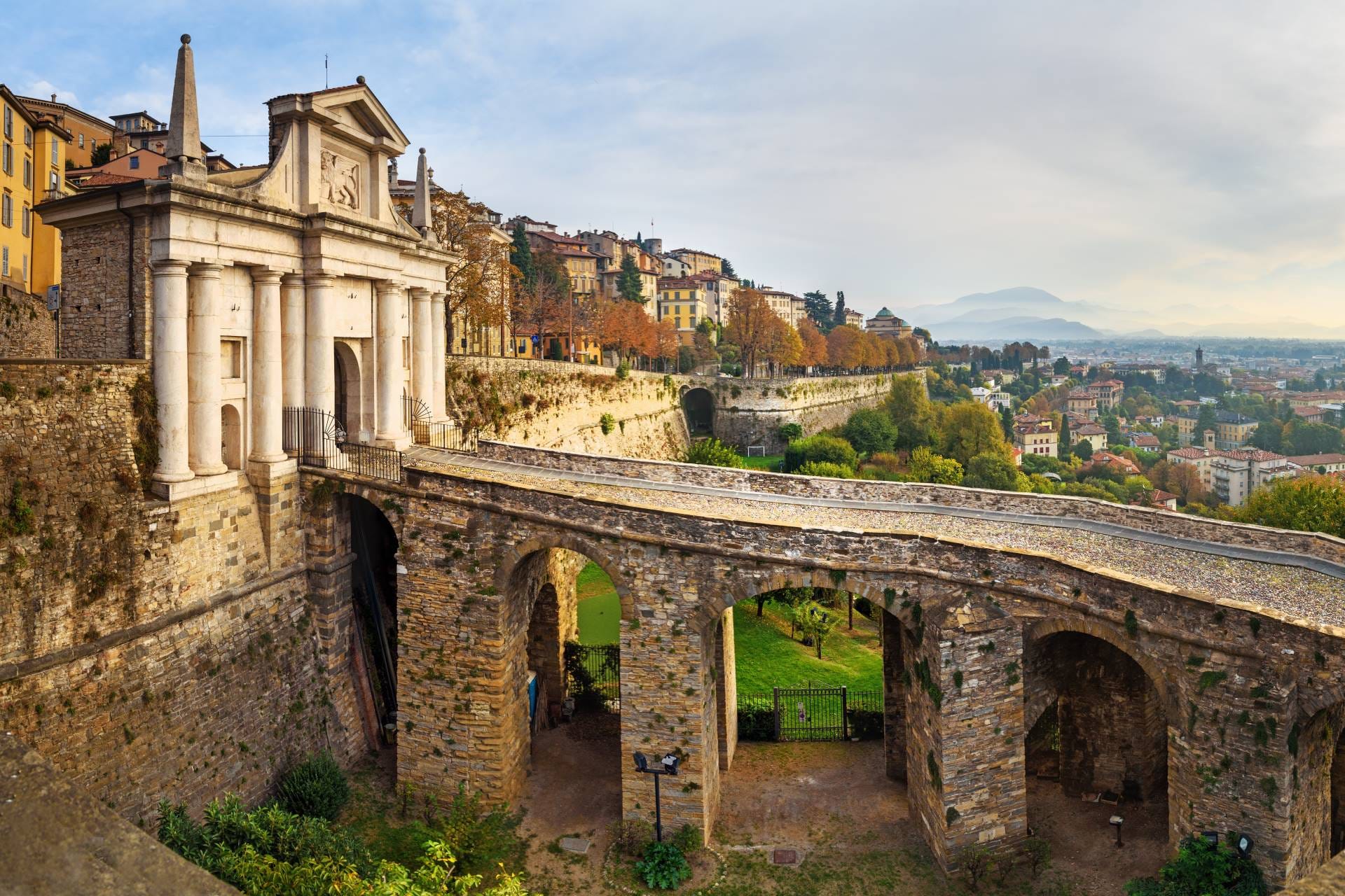 Morning view of the white marble Porta San Giacomo gate and the UNESCO Venetian Walls in Bergamo.