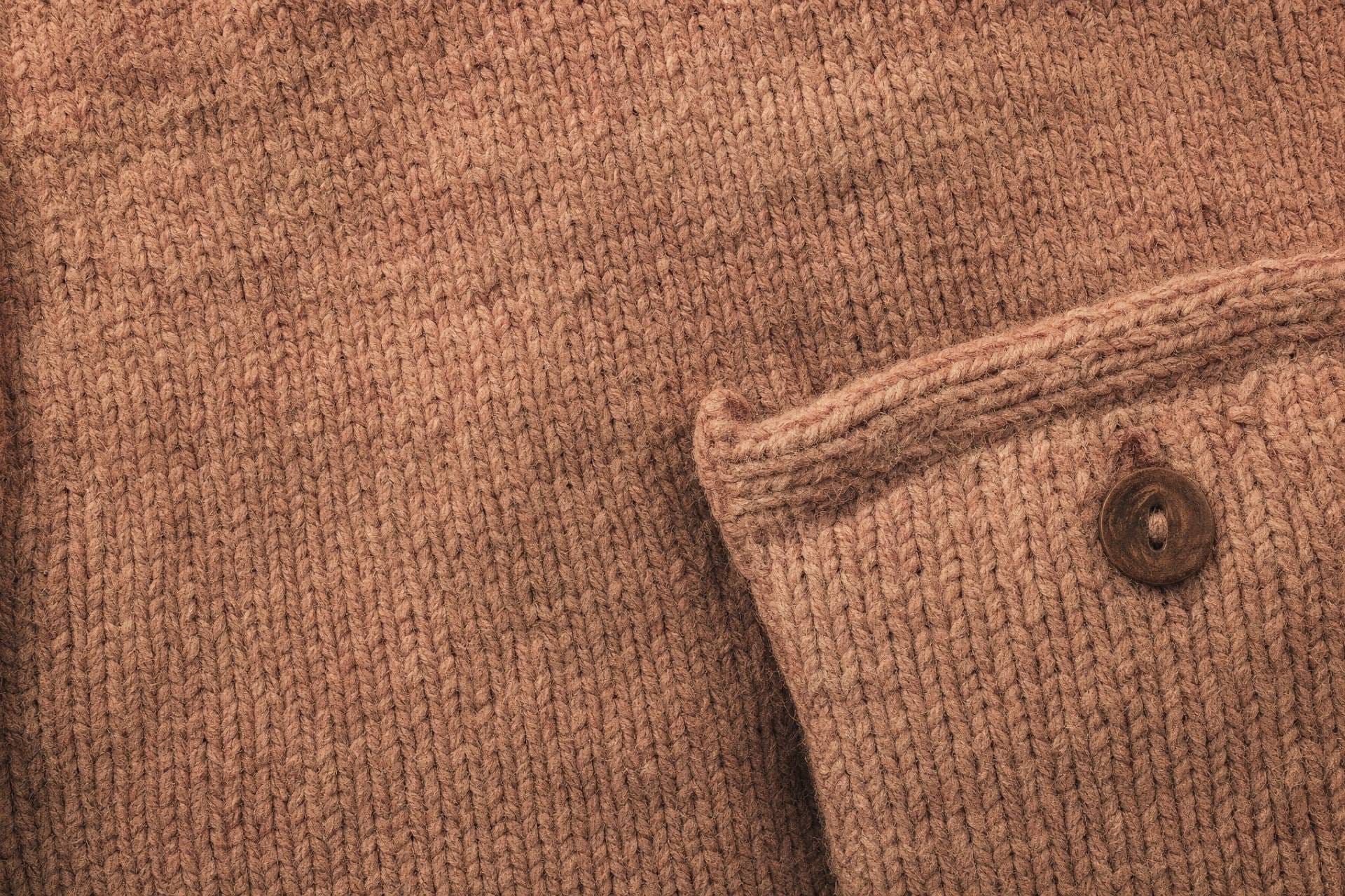 Close-up of faded rose knitted wool, the heavy fabric of the original maglia rosa pink jersey