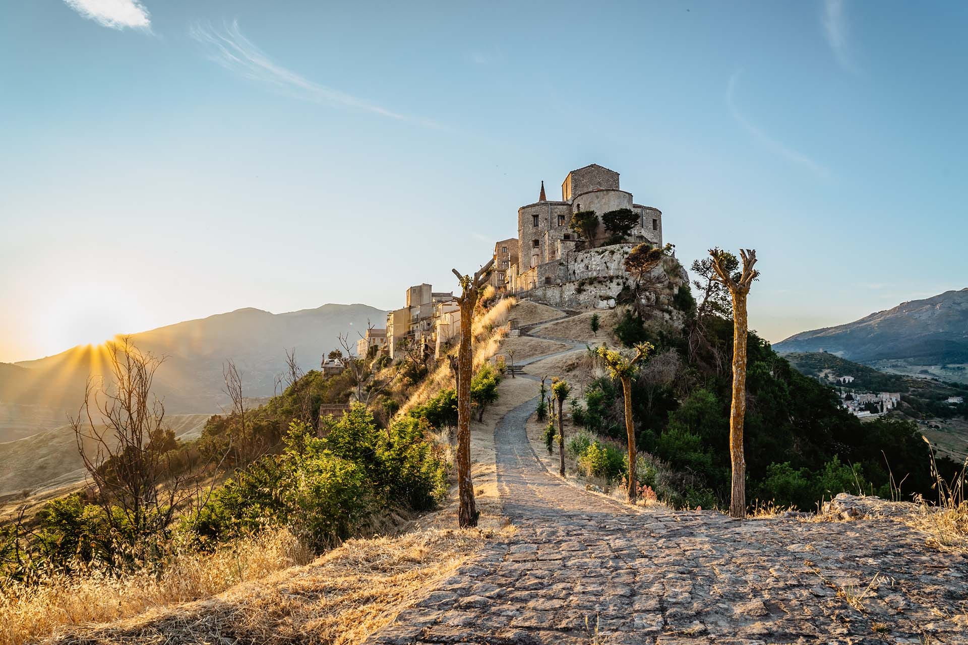 Stone village of Petralia Soprana and the Church of Santa Maria di Loreto at sunset, Madonie Regional Natural Park, Sicily, Italy.