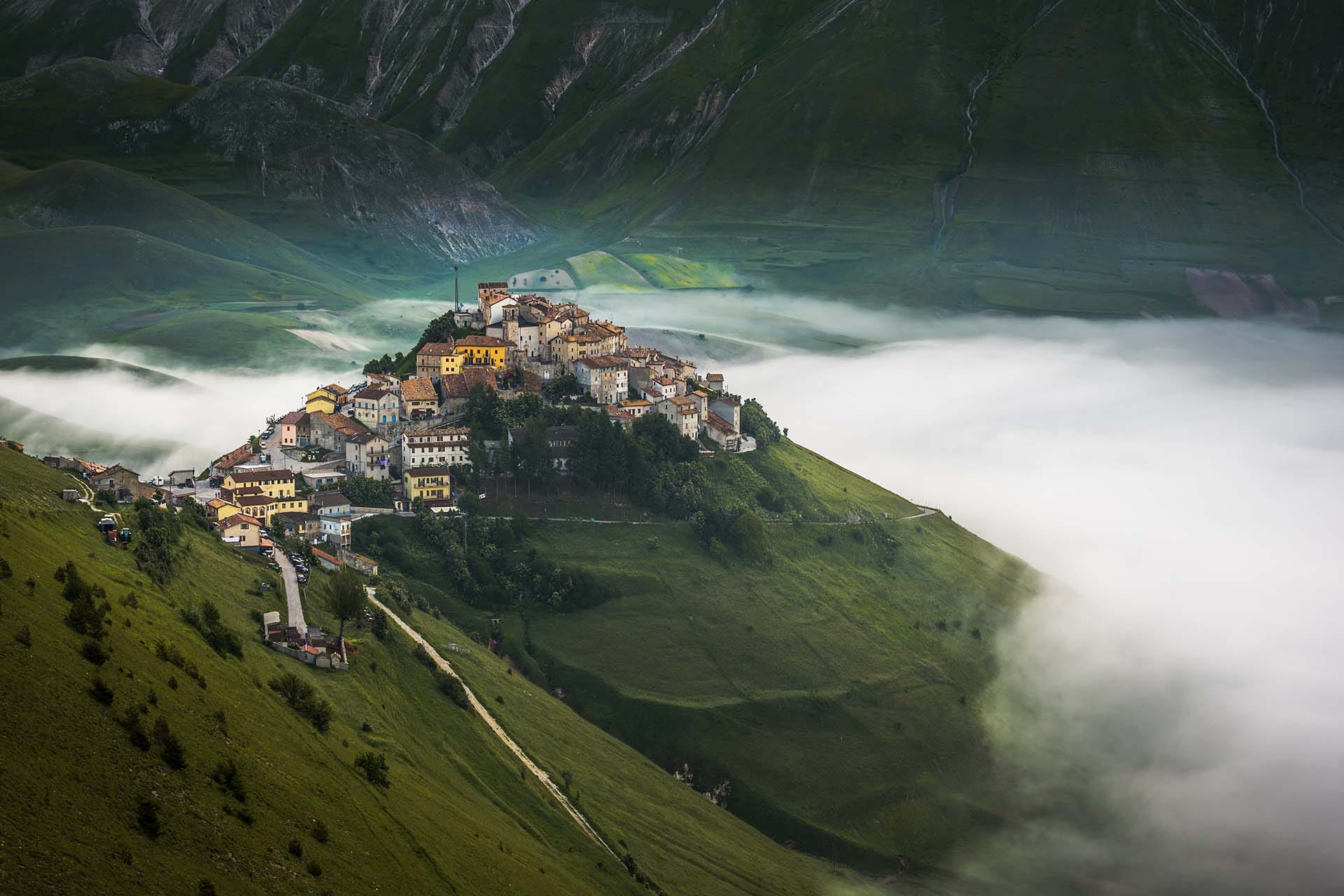 Panoramic aerial view of the Piano Grande plateau at Castelluccio di Norcia, Monti Sibillini National Park, Umbria, Italy.
