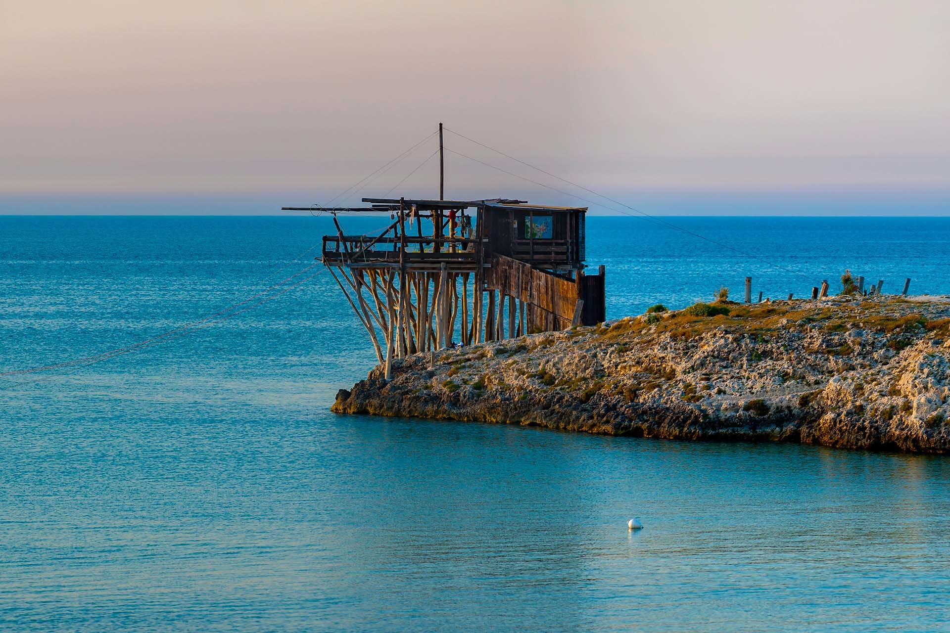 Traditional trabucco fishing machine on the Adriatic coast of Gargano National Park, Puglia, Italy, protected as monumental heritage.