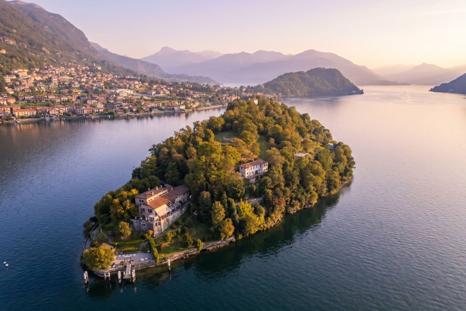 Aerial view of the Isola Comacina on Lake Como at golden hour, with the Locanda at its southern tip