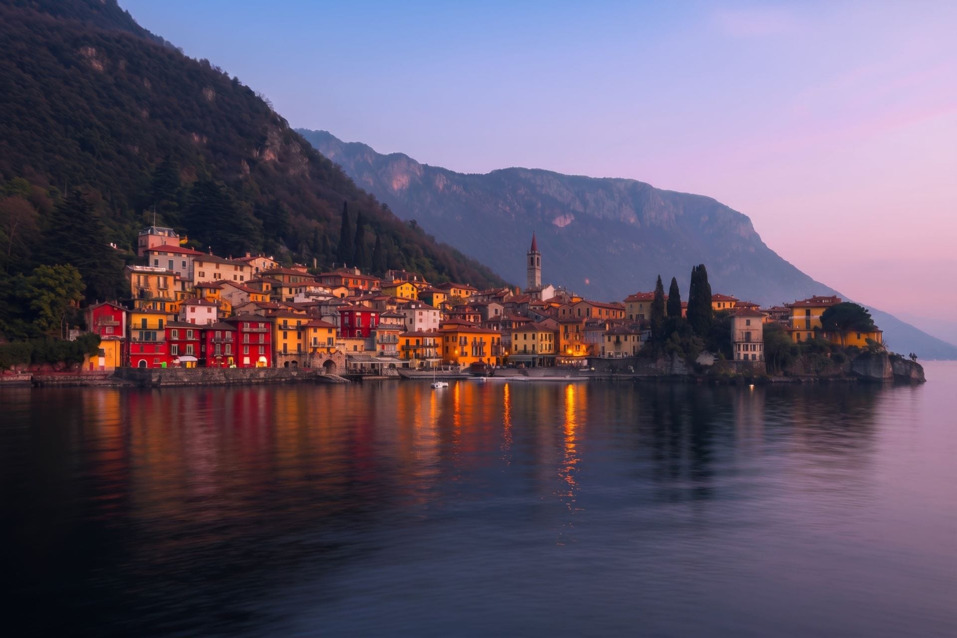 Colorful houses of Varenna on the eastern shore of Lake Como at afterglow, lamplight on water