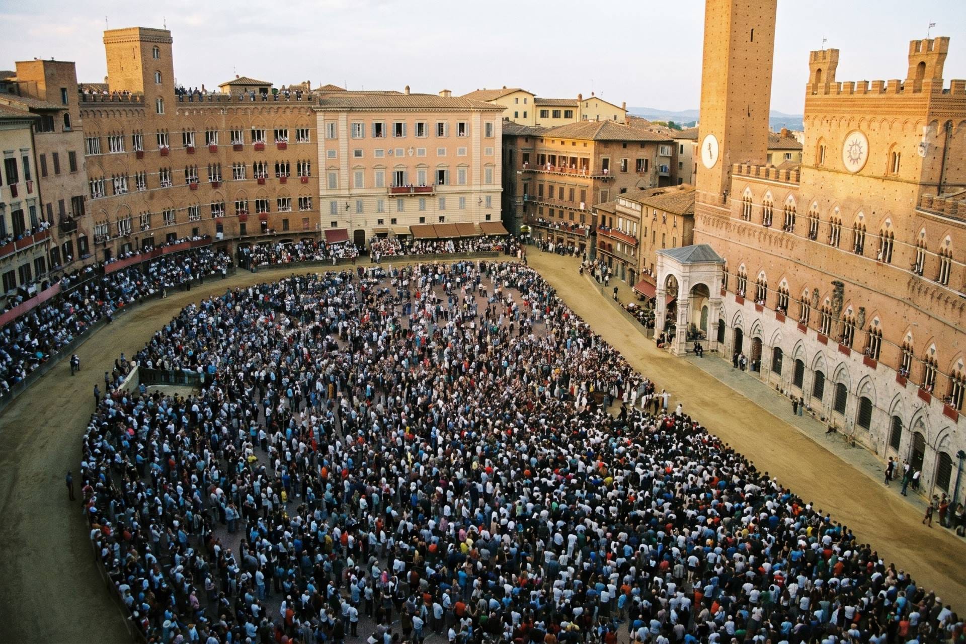 Crowds gathering in Piazza del Campo by the Palazzo Pubblico before the Palio di Siena