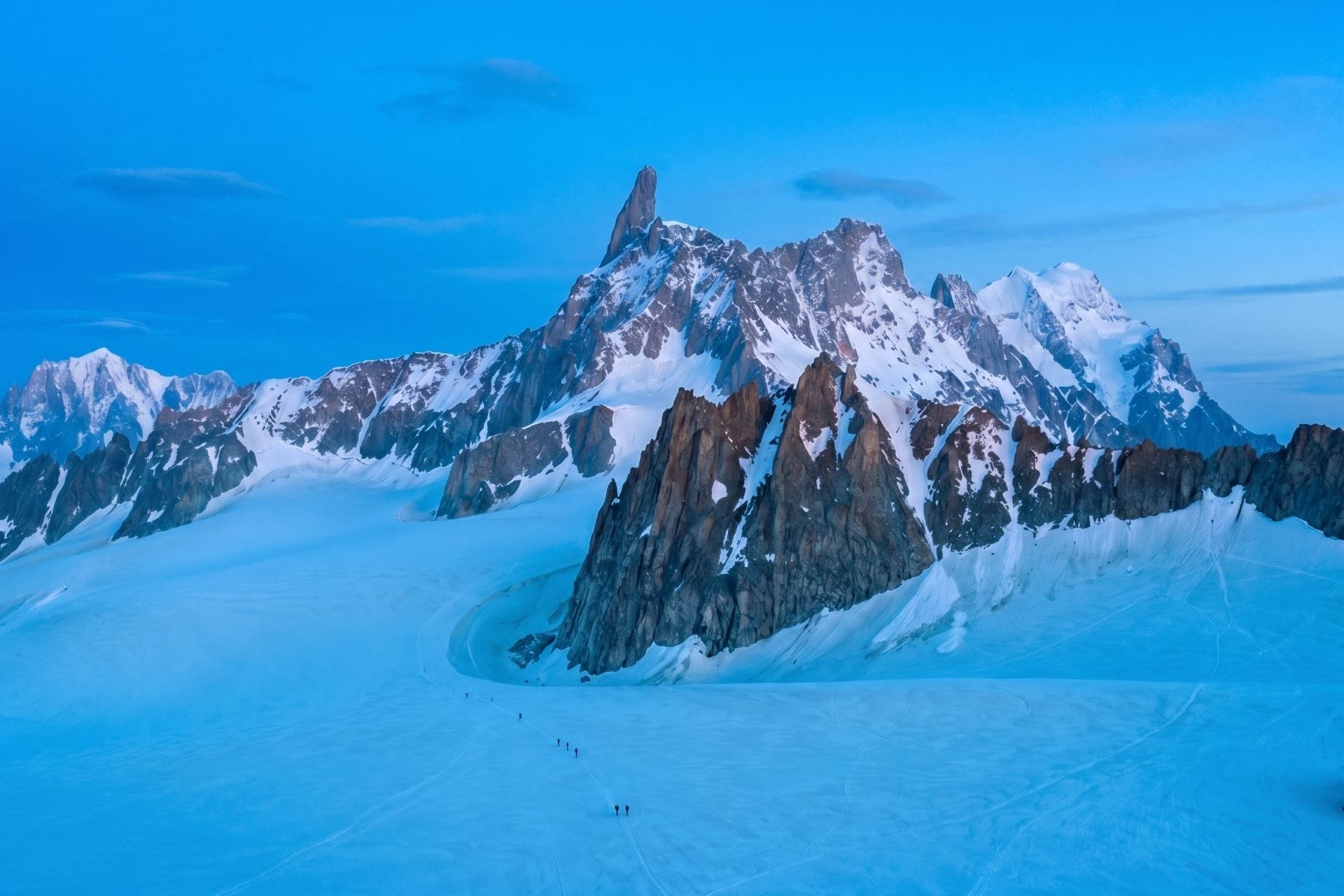 Roped climbers on the Géant glacier below the Dente del Gigante near Courmayeur at dusk
