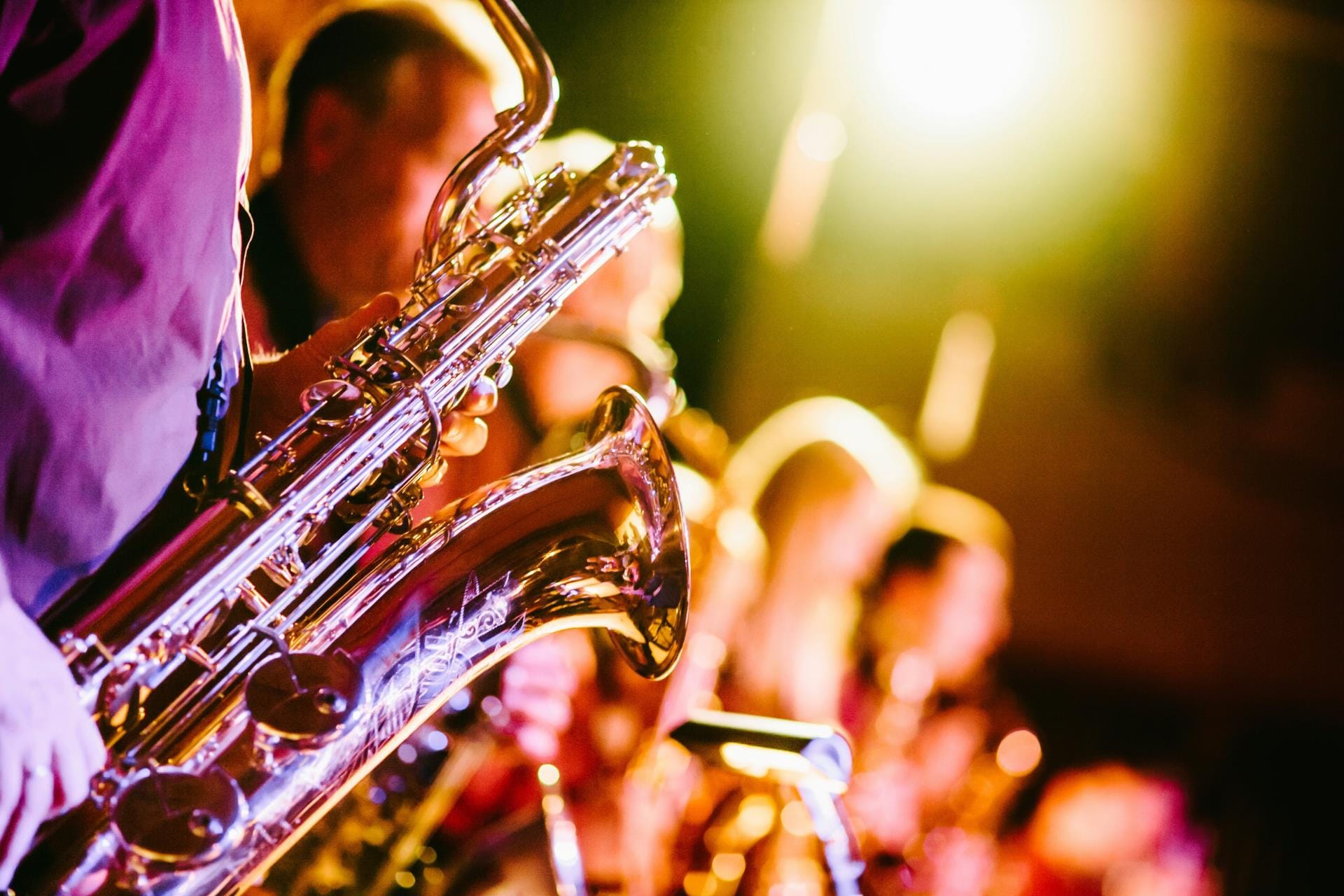 Brass saxophone in warm stage light at an evening jazz concert, Umbria Jazz festival
