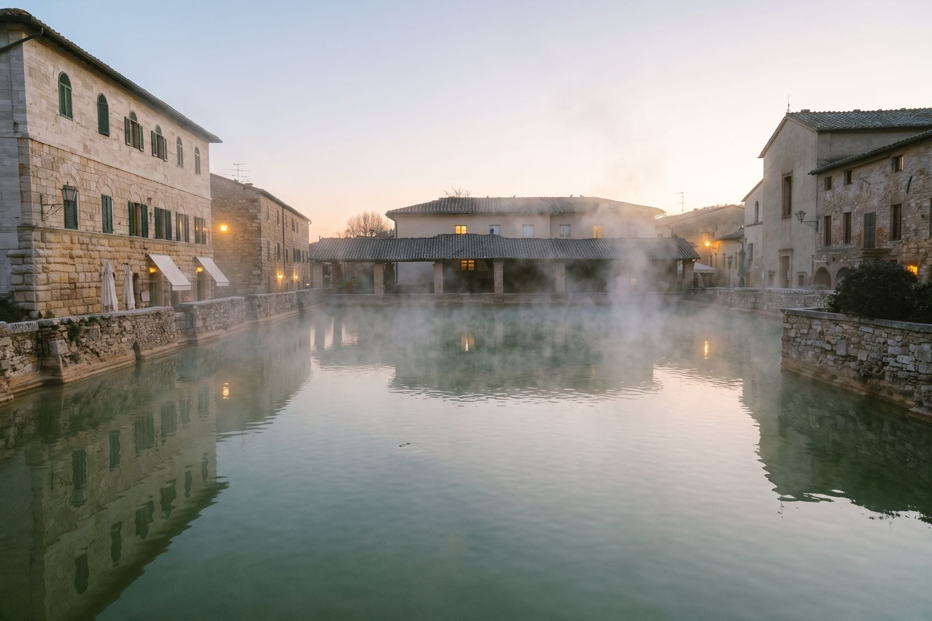 Steaming thermal pool of Bagno Vignoni at dawn, Val d'Orcia