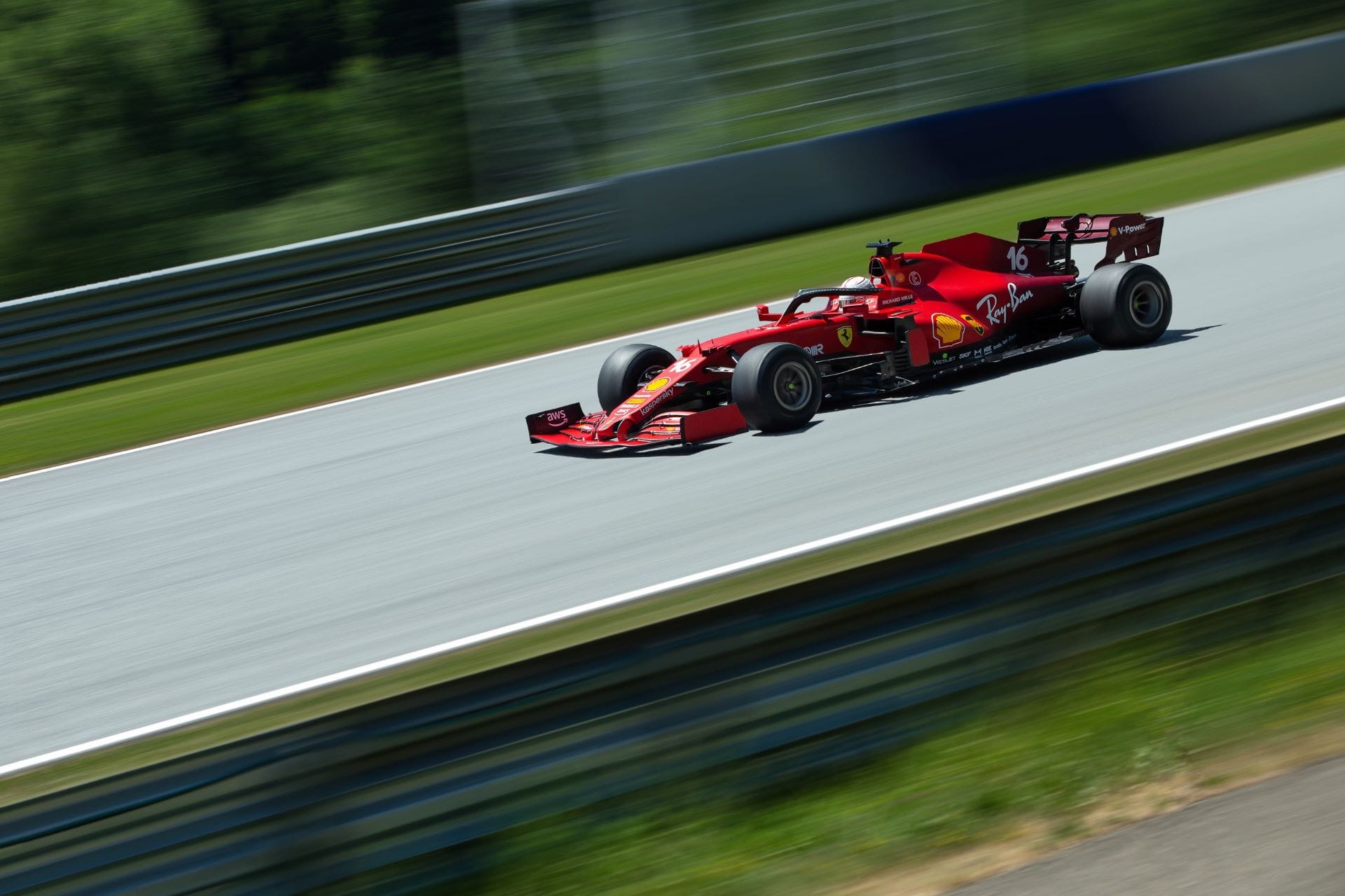 Ferrari Formula 1 car number 16 cornering at speed in red livery