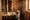 White grape must under a wooden torchio press in a Langhe wine cellar / Image edited with ai from a reference photograph