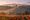 Vineyards and olive groves on the hills below Montefalco in Umbria during the October harvest / Image edited with ai from a reference photograph.