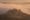 Podere Belvedere farmhouse surrounded by cypress trees in Val d'Orcia fog at dawn