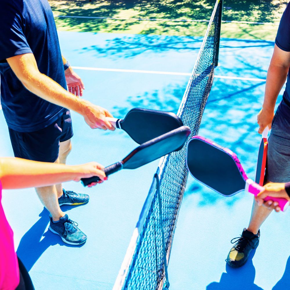 Two people playing pickleball with composite pickleball paddles