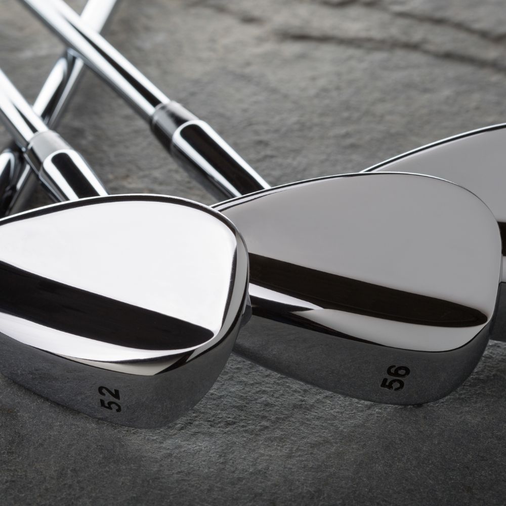 A golfer holding a Cleveland RTX Zipcore, TaylorMade Milled Grind 3 (MG3) and Callaway Mack Daddy CB Wedge
