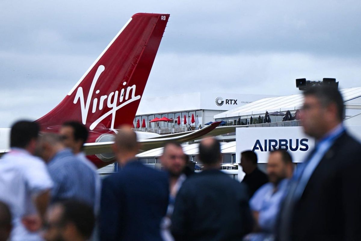 Visitors stand near an Airbus A330-900 on the second day of the Farnborough International Airshow 2024, south west of London, on July 23, 2024. 