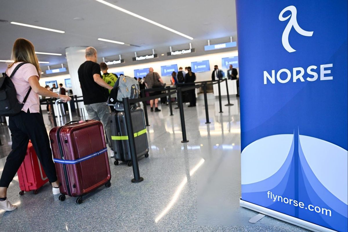 Passengers check-in with baggage for a Norse Atlantic Airways inaugural flight to Oslo