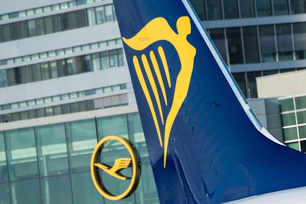 Irish low-cost airline Ryanair (R) can be seen on a plane standing at the airport in Frankfurt am Main, western Germany, as in background can be seen the logo of German airline Lufthansa