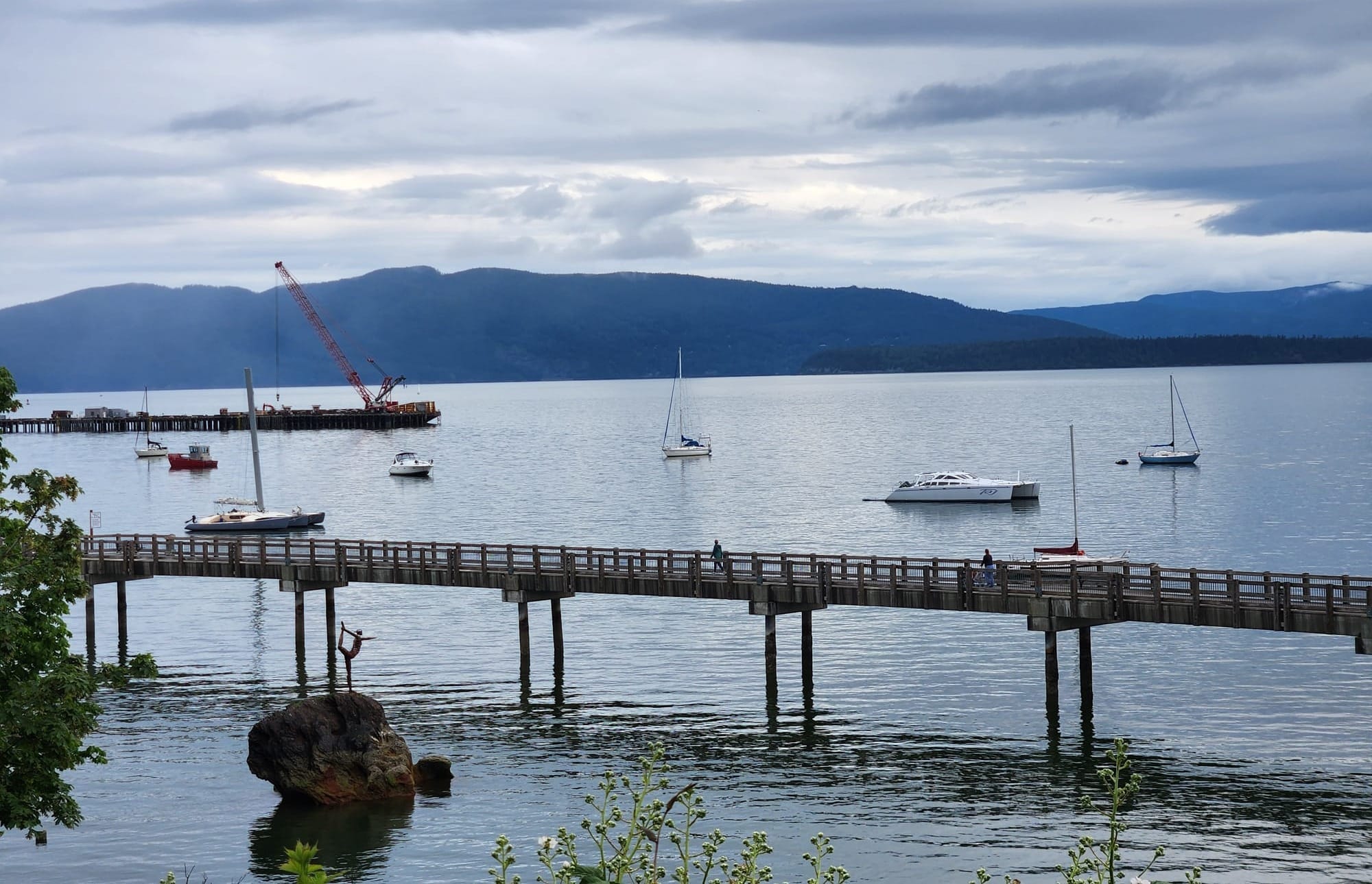 A view of Lummi Island with Bellingham Bay and the South Bay Trail boardwalk in the foreground.