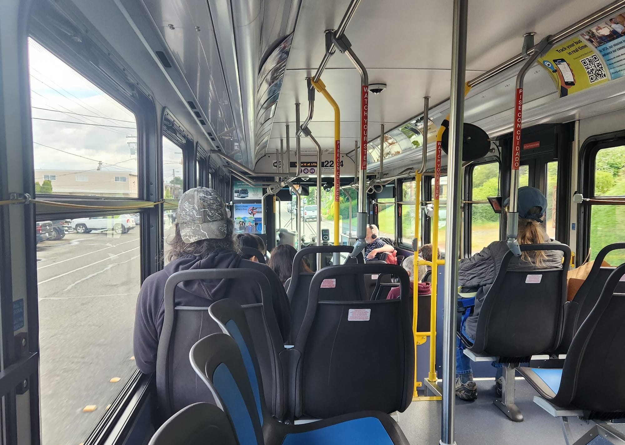An interior photo of a Route 1 bus with a few passengers distributed around the coach.