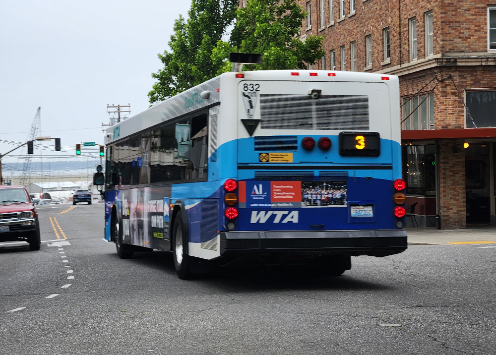 A Route 3 WTA bus travels west on W. Champion Street.